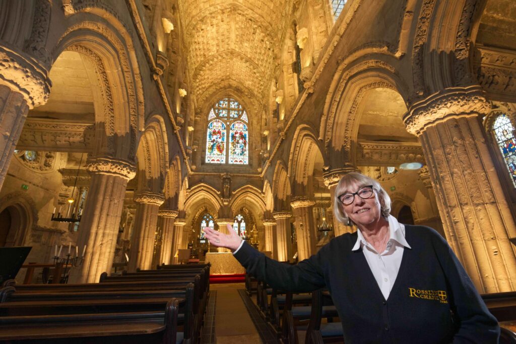 Guide Jenny Beddoe-Stephens shows off new lighting which has just been installed in Rosslyn Chapel, in Midlothian. The new lights illuminate twelve of the Chapel’s arches and will help visitors appreciate more of the Chapel’s medieval  stone carvings, which were previously in shadow. The LED lights have been specifically made for the Chapel by Stoane Lighting, also from Midlothian. Rosslyn Chapel is open to visitors all year.    MORE INFO: IAN GARDNER 0131 440 2159