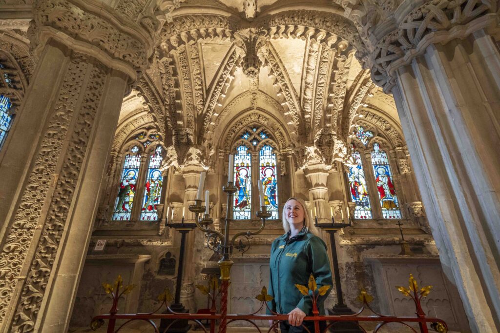 Visitor guide Megan Finlay takes a closer look at The Lady Chapel, the most ornately carved area of Rosslyn Chapel in Roslin, Midlothian, which has been illuminated with newly refurbished lighting to allow visitors to see more of the detailed stone work. Picture date: Tuesday February 4, 2025. PA Photo. Photo credit should read: Jane Barlow/PA Wire